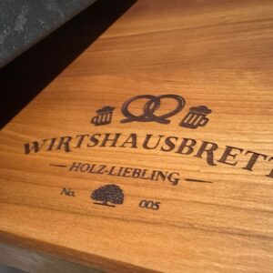 Cherry tree cutting board made from old Bavarian pub tables with wooden favorite pub board engraving