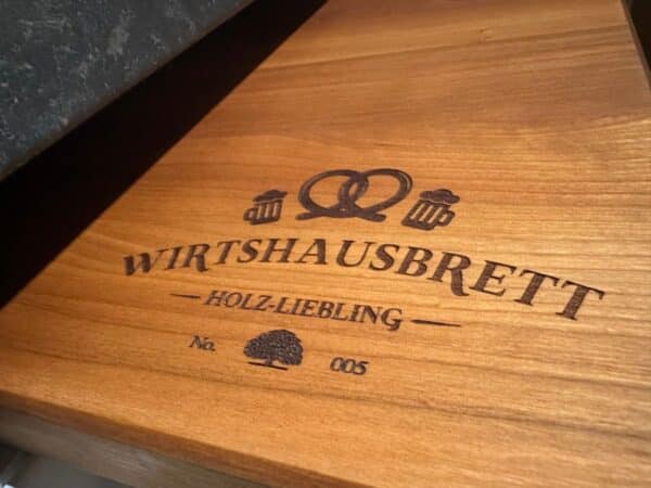 Cherry tree cutting board made from old Bavarian pub tables with wooden favorite pub board engraving